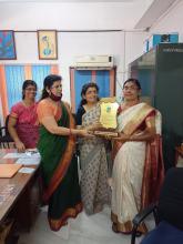 HANDING OVER A TOKEN OF LOVE FOR HER SERVICE IN OUR VIDYALAYA 